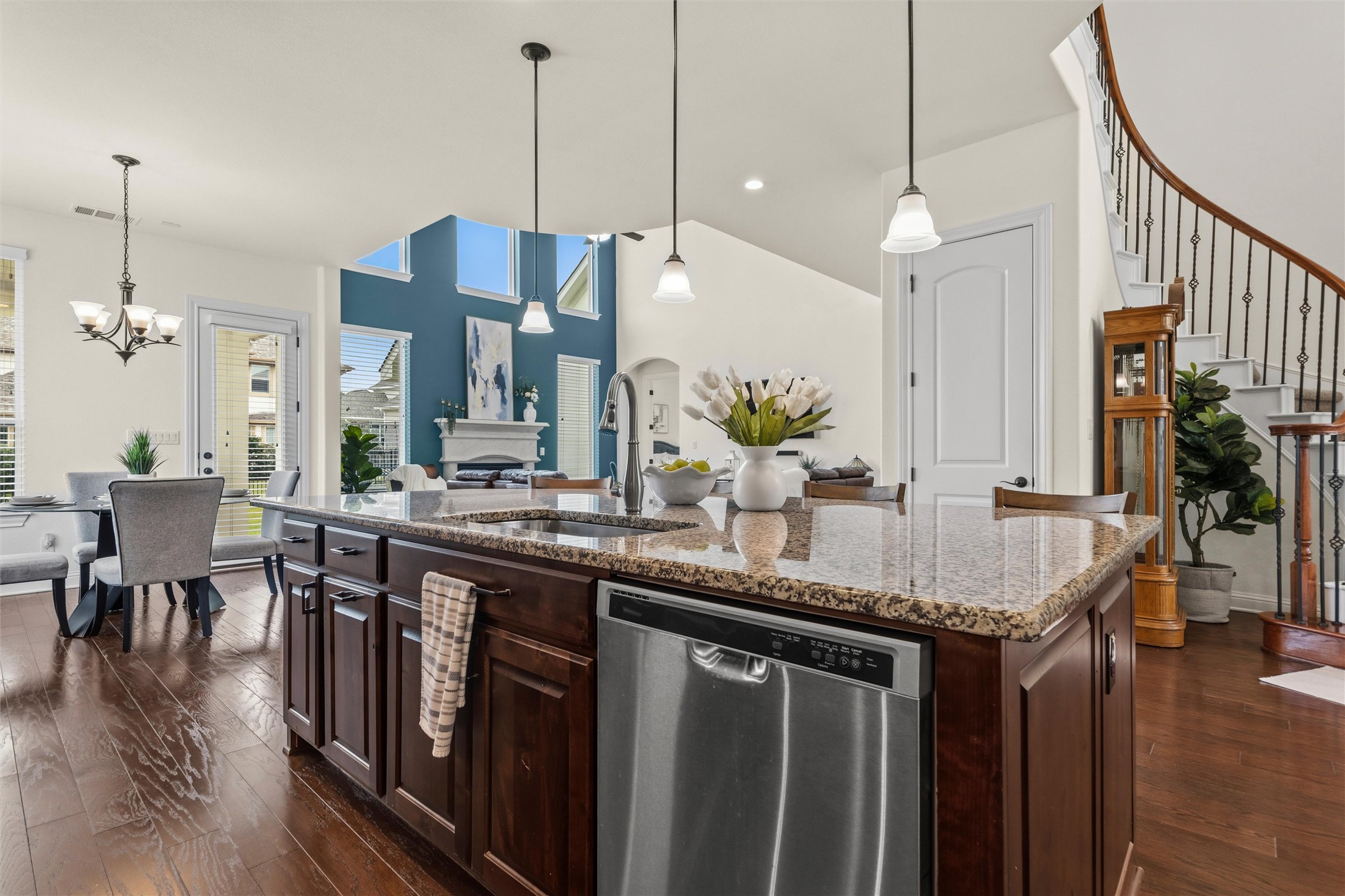 1733 Siena Sunset Road Leander, TX 78641 - Photo 19 of 40 Kitchen island featuring granite-style countertops, stainless steel appliances, and pendant lighting