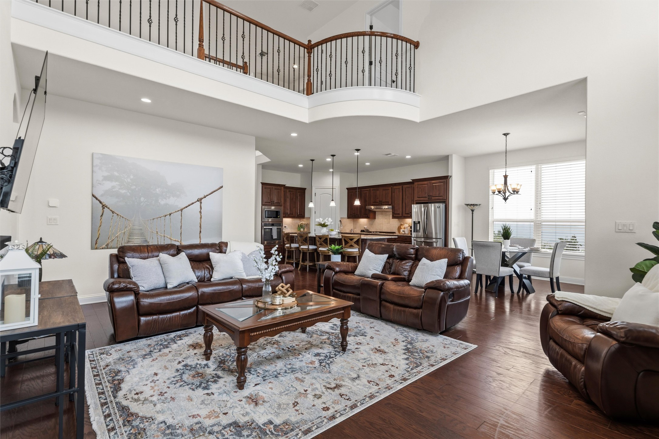 1733 Siena Sunset Road Leander, TX 78641 - Photo 25 of 40 Expansive living area featuring high ceilings and dark wood-finish flooring