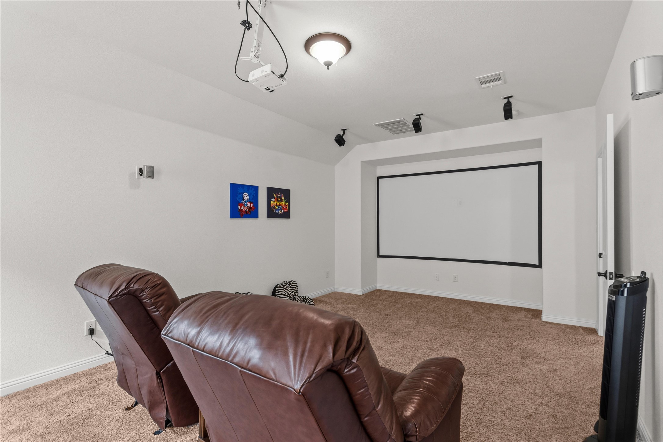 1733 Siena Sunset Road Leander, TX 78641 - Photo 34 of 40 Dedicated media room featuring a large projector screen, ceiling-mounted projector, recessed ceiling speakers, and track lighting
