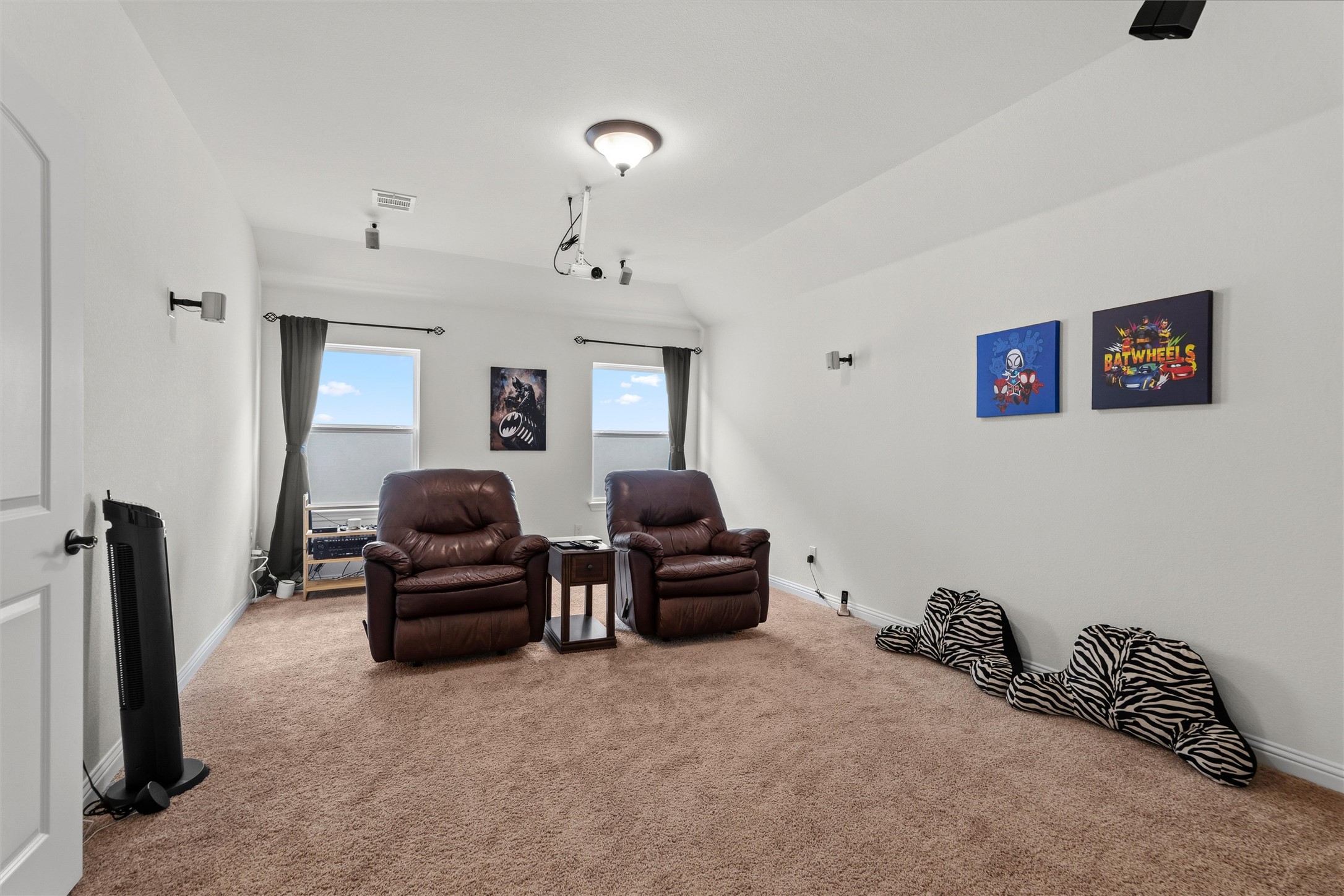 1733 Siena Sunset Road Leander, TX 78641 - Photo 35 of 40 Spacious room featuring neutral carpeting, white walls, and a ceiling-mounted projection system