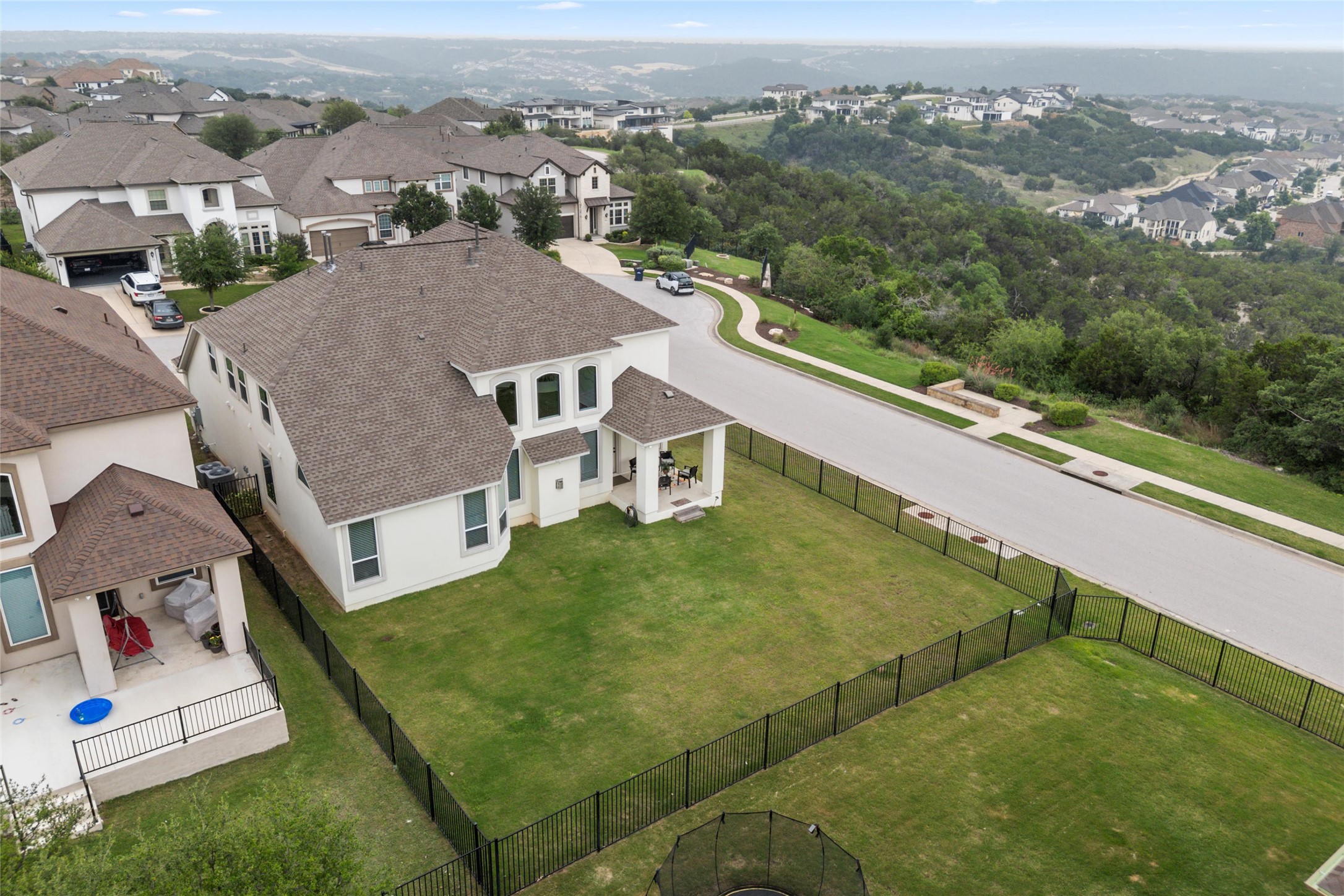 1733 Siena Sunset Road Leander, TX 78641 - Photo 7 of 40 Two-story residence with a light-toned exterior and a brown shingle roof