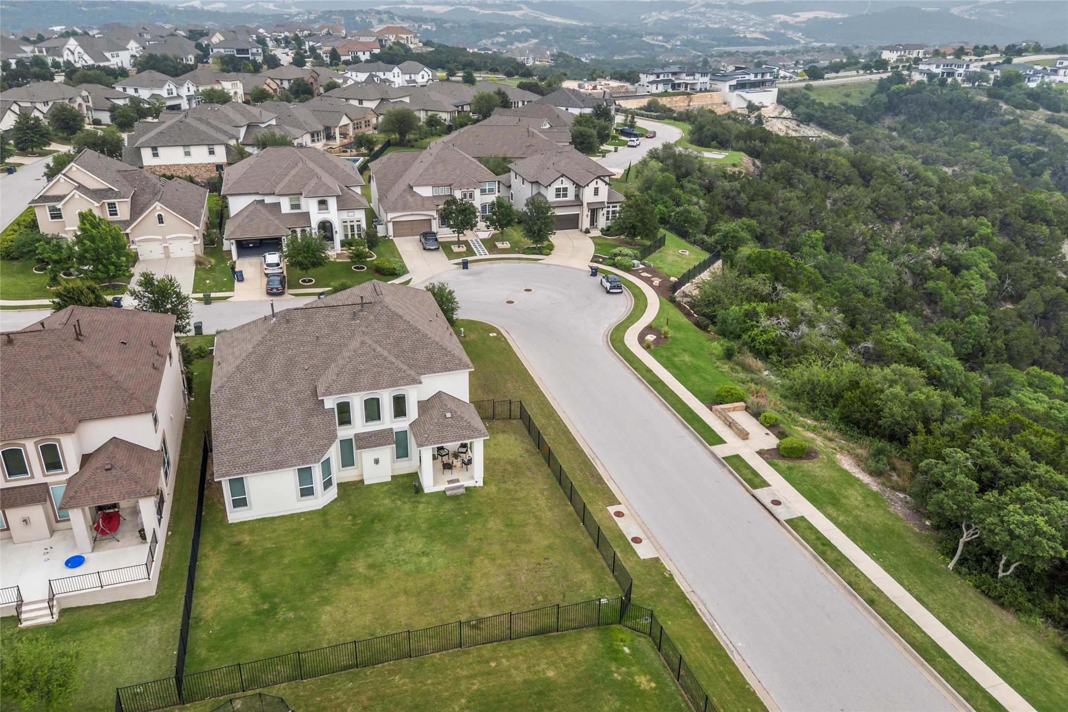 1733 Siena Sunset Road Leander, TX 78641 - Photo 9 of 40 Residential neighborhood featuring a paved street, sidewalks, and streetlights