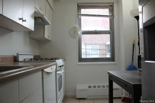 a kitchen with stainless steel appliances a sink a stove and a window