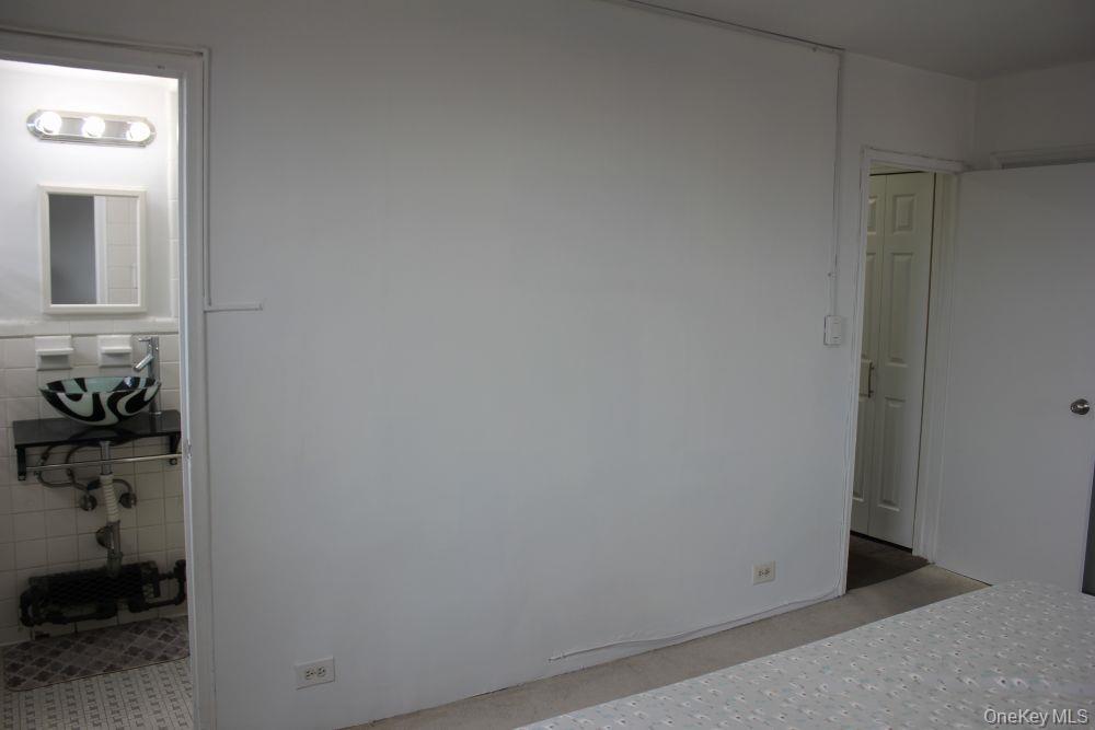 61-25 97th Street, Unit 15J Queens, NY 11374 - Photo 13 of 17 a bathroom with a shower