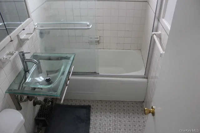 a bathroom with a sink and mirror