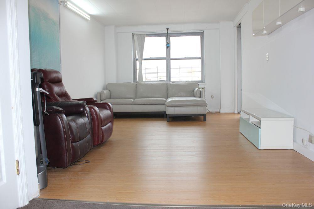 61-25 97th Street, Unit 15J Queens, NY 11374 - Photo 3 of 17 a living room with furniture and a window