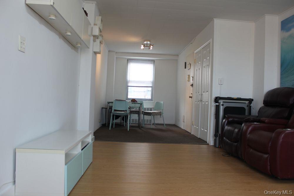 61-25 97th Street, Unit 15J Queens, NY 11374 - Photo 4 of 17 a view of a livingroom with furniture and windows