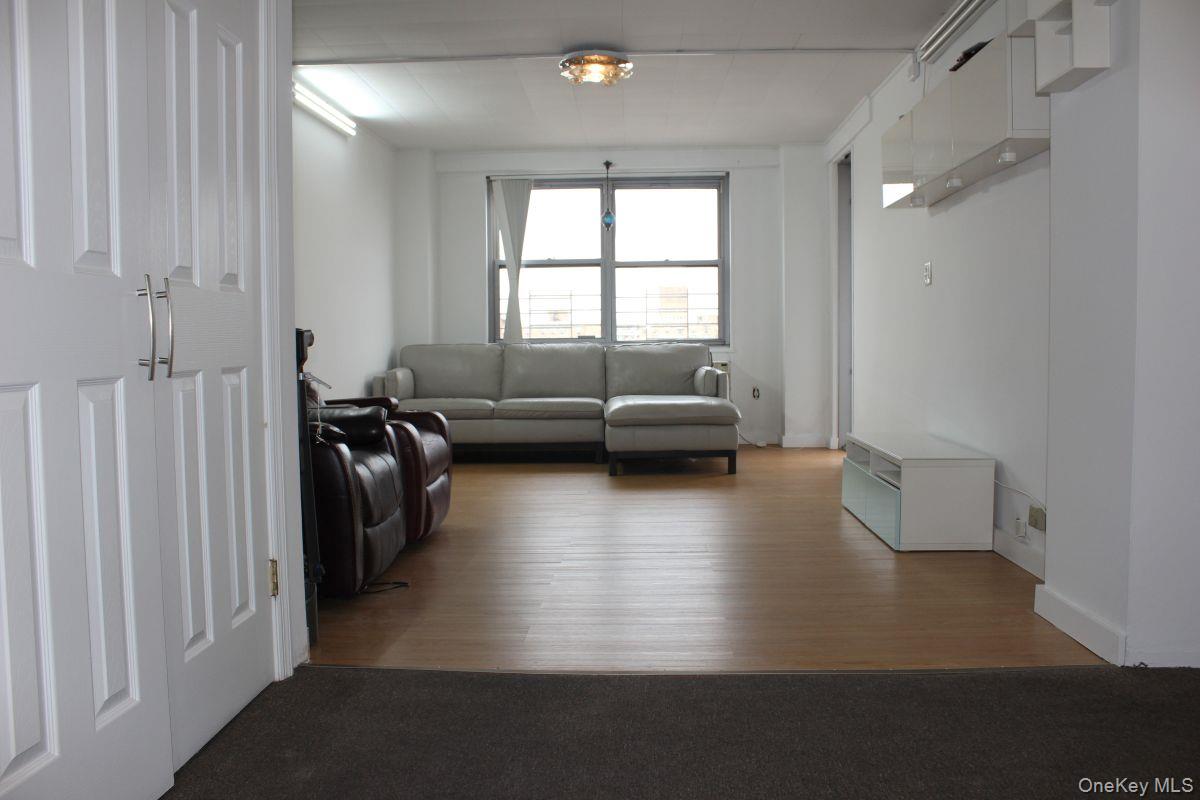 61-25 97th Street, Unit 15J Queens, NY 11374 - Photo 6 of 17 a view of a living room and hardwood floor