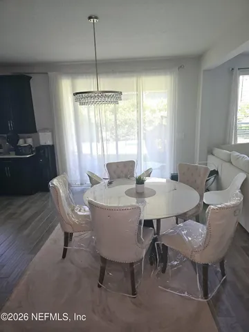 a view of a dining room with furniture window and outside view