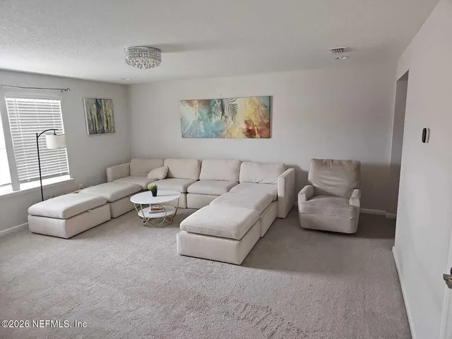 a living room with furniture and a couch