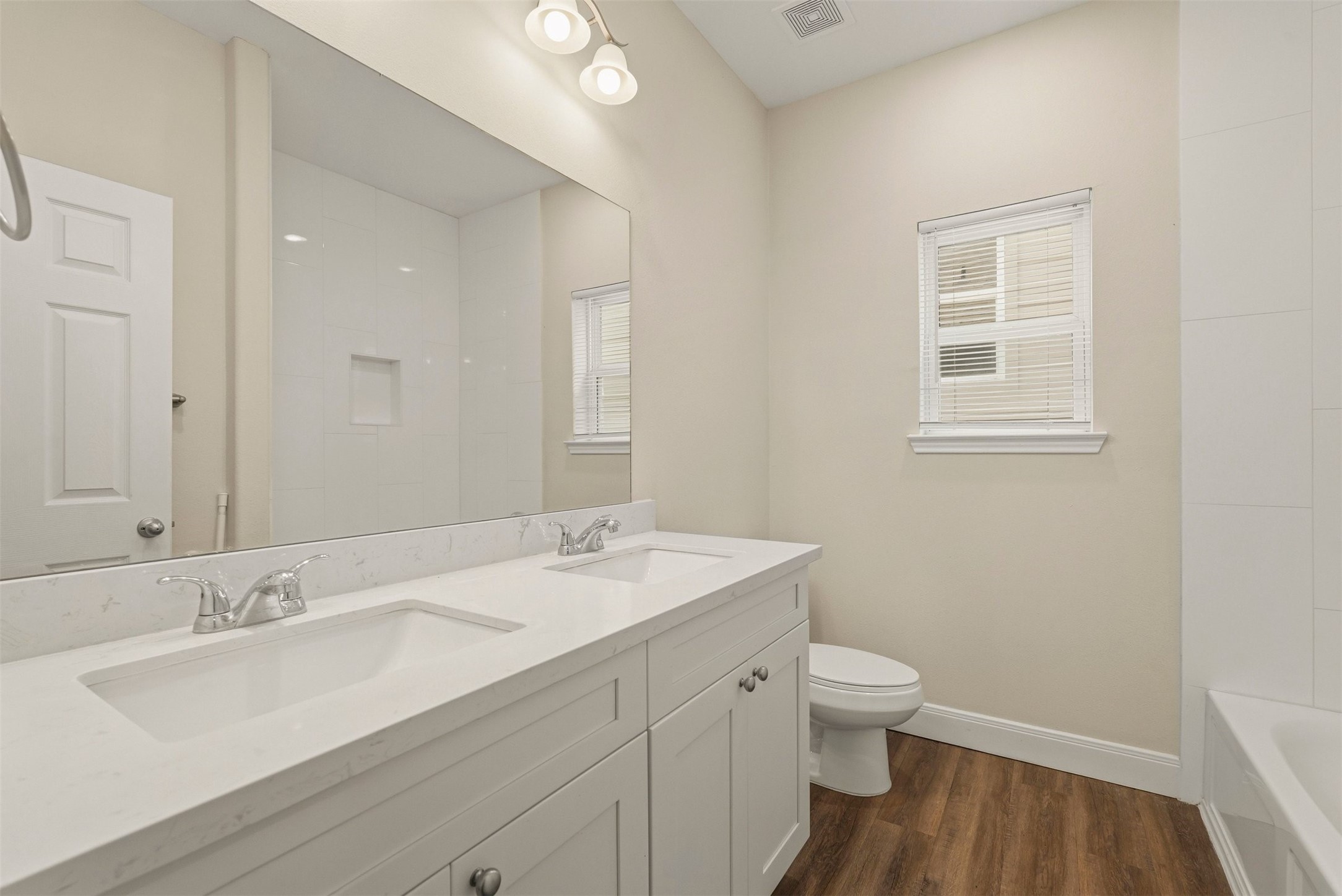 2218 Bringhurst Street, Unit B Houston, TX 77026 - Photo 19 of 25 a bathroom with a sink a toilet and a mirror