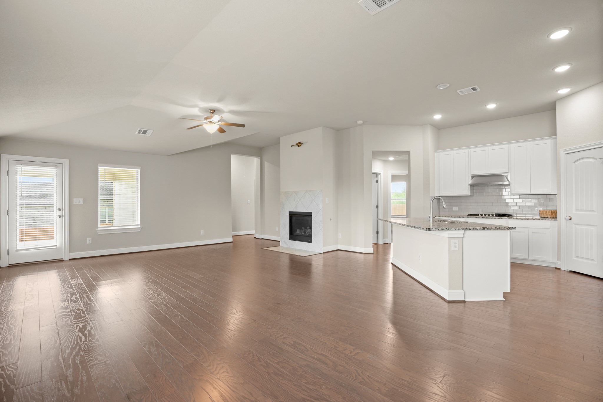 2209 Hat Bender Loop Round Rock, TX 78664 - Photo 4 of 25 a view of an empty room and kitchen with wooden floor and a window