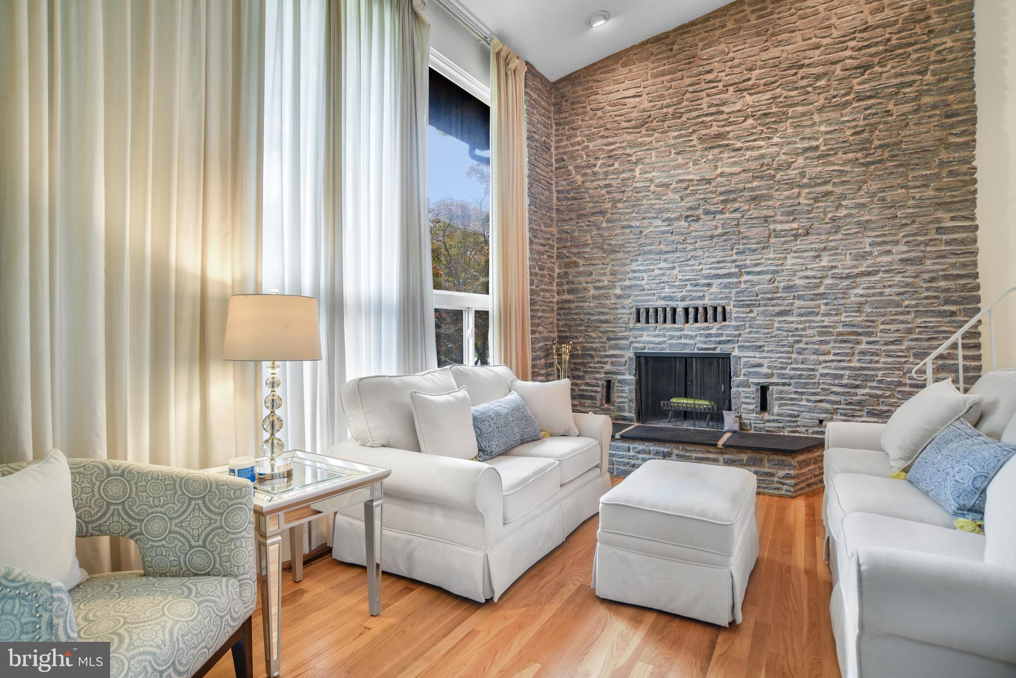 8239 Brattle Road Pikesville, MD 21208 - Photo 4 of 27 Living room - hardwood floors and fireplace