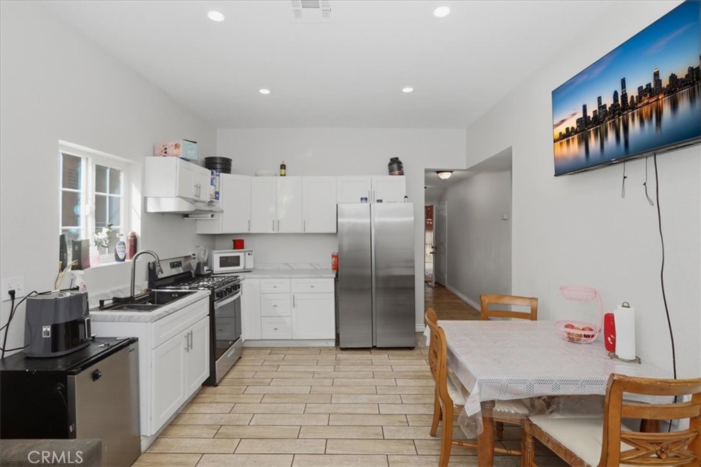 245 Commercial Avenue Riverside, CA 92507 - Photo 11 of 30 a kitchen with granite countertop a refrigerator stove and sink