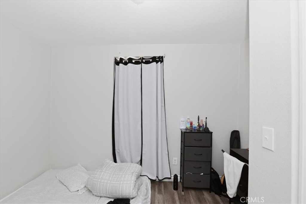 245 Commercial Avenue Riverside, CA 92507 - Photo 16 of 30 a view of a bedroom with a closet and wooden floor