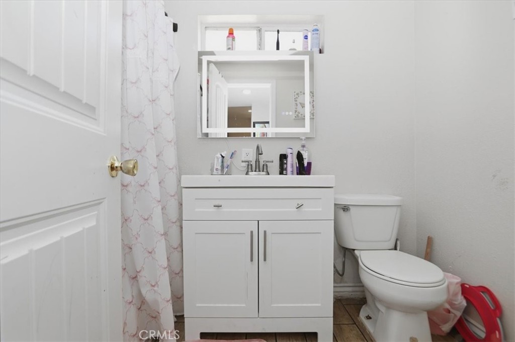 245 Commercial Avenue Riverside, CA 92507 - Photo 18 of 30 a bathroom with a toilet sink vanity and mirror