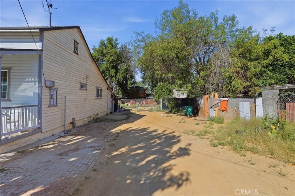 245 Commercial Avenue Riverside, CA 92507 - Photo 25 of 30 a backyard of a house with a tree and wooden fence