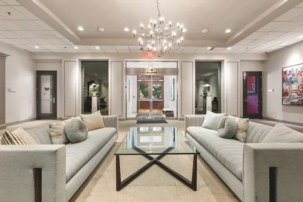 a living room with furniture and a chandelier