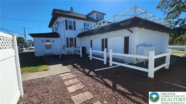 a front view of a house with large windows