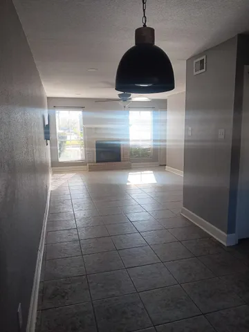 a view of a hallway with a chandelier