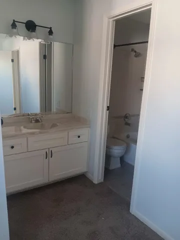 an empty room with a ceiling fan and a window