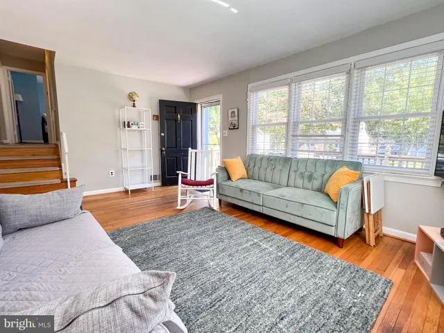 a living room with furniture rug and window