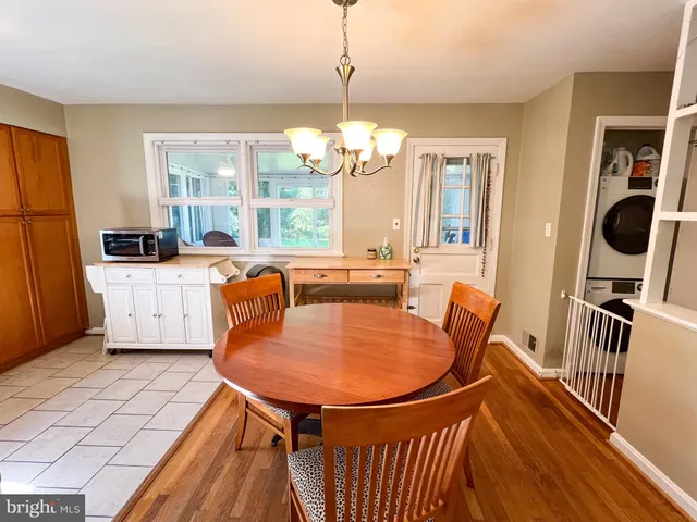 a view of house with garden space and sitting area