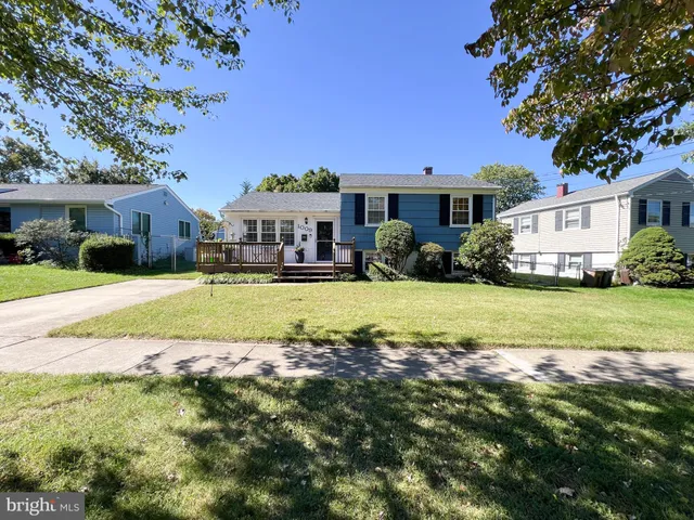 a view of a house with a big yard and large trees