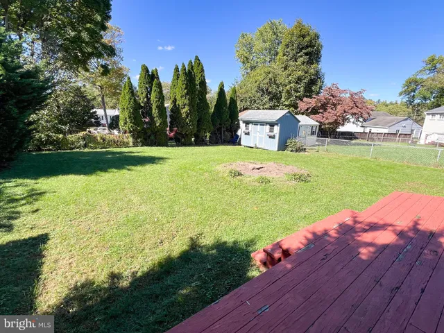 a bedroom with a bed and a flat tv screen on dresser