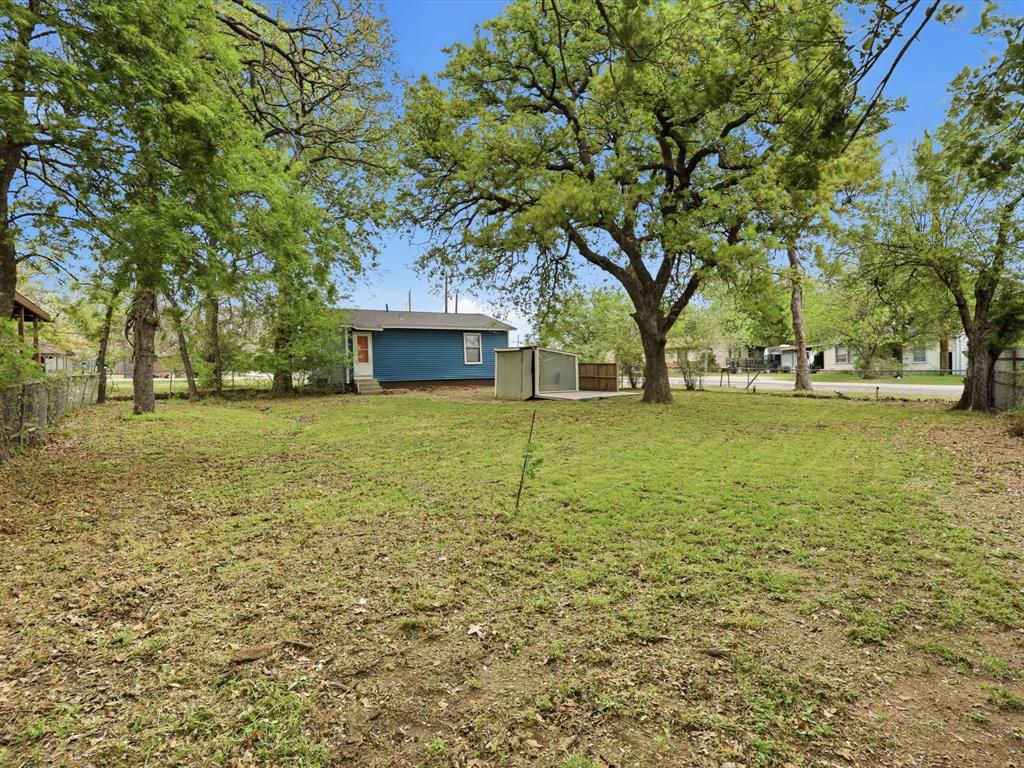 632 North Stewart Street Azle, TX 76020 - Photo 25 of 26 View of yard featuring a storage unit