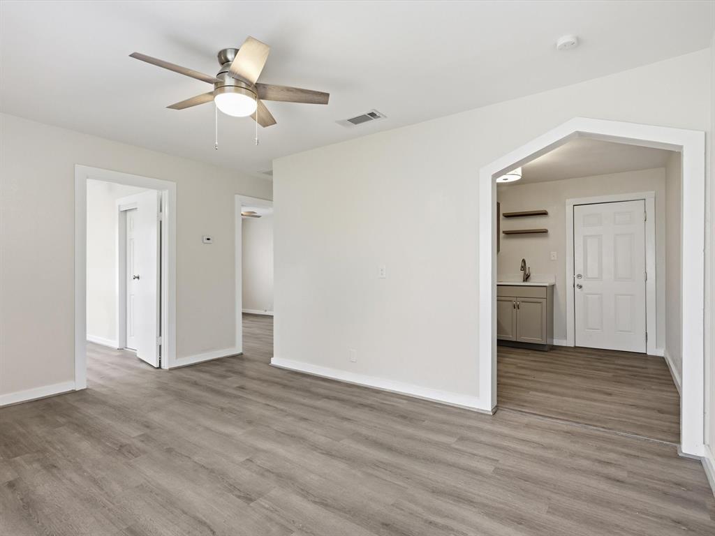 632 North Stewart Street Azle, TX 76020 - Photo 10 of 26 Empty room with ceiling fan and light wood-style flooring