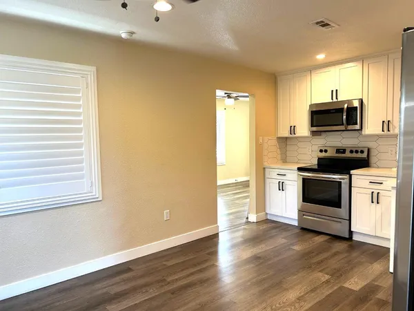 a kitchen with a stove a sink and a microwave