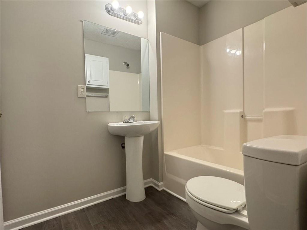 4044 Robin Circle Atlanta, GA 30349 - Photo 11 of 12 a bathroom with a sink toilet and shower