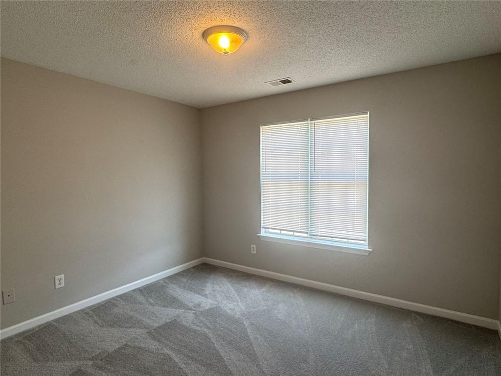 4044 Robin Circle Atlanta, GA 30349 - Photo 7 of 12 an empty room with a window