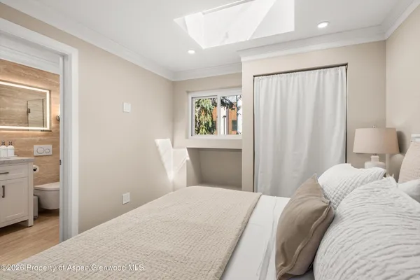 a bathroom with a granite countertop sink a mirror a bathtub and shower