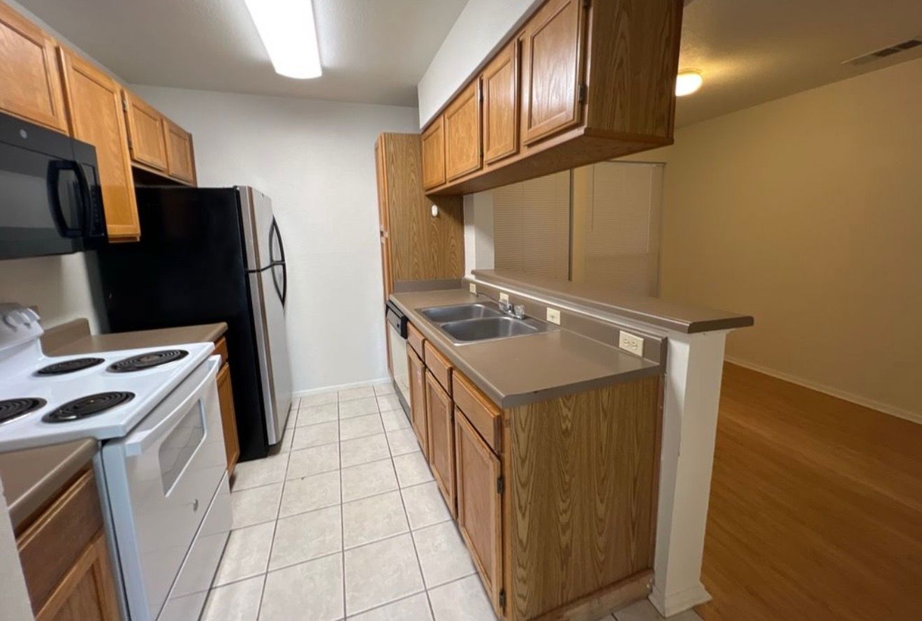 3115 Helms Street, Unit 111 Austin, TX 78705 - Photo 1 of 13 A well-appointed kitchen showcases ample cabinetry and practical counter space, perfect for daily routines.