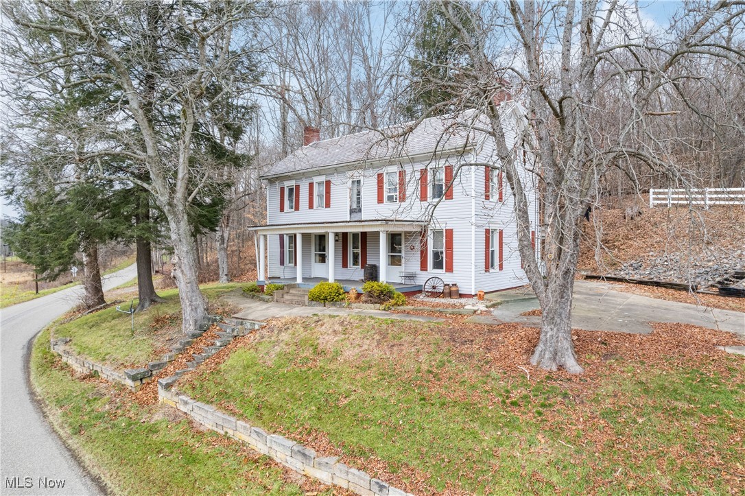 5147 Bluebird Road Northwest Malvern, OH 44644 - Photo 3 of 26 Colonial inspired home featuring covered porch and a front yard