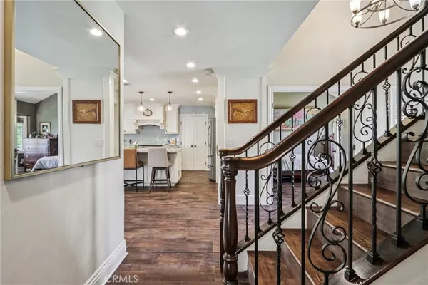 a living room with furniture and stairs