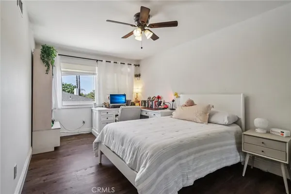 a bedroom with a bed and a ceiling fan