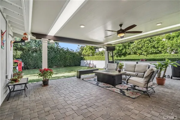 a living room with patio furniture and a floor to ceiling window