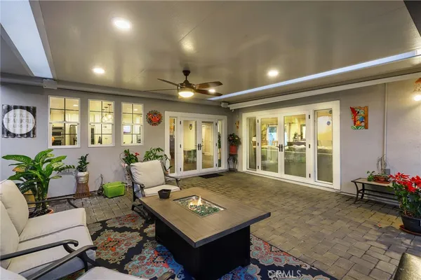 a living room with furniture and floor to ceiling window