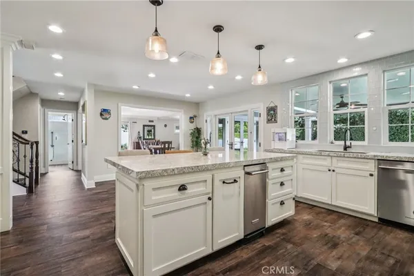 a kitchen with stainless steel appliances granite countertop cabinets a sink and a stove