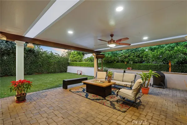 a living room with patio furniture and a garden