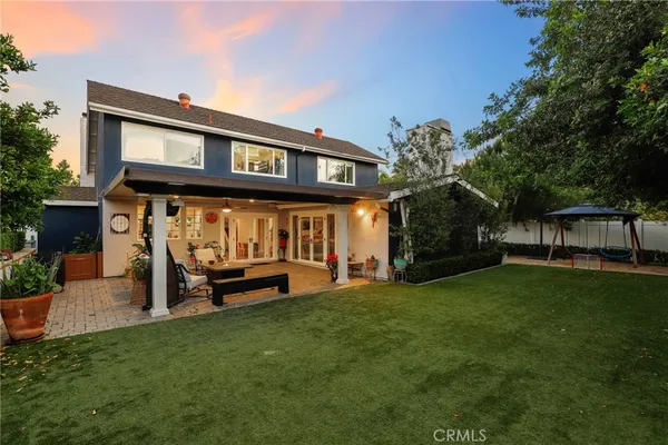 a front view of a house with a garden and plants
