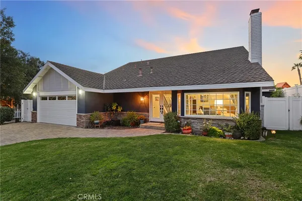 a view of a house with a yard porch and sitting area
