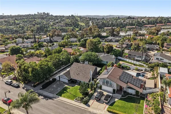 an aerial view of residential houses with outdoor space