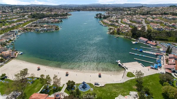 an aerial view of lake with residential houses with outdoor space
