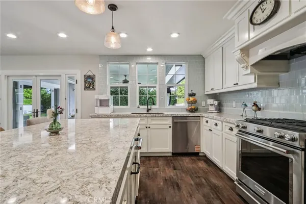 a kitchen with sink stove and cabinets