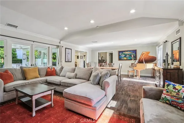 a living room with furniture a rug and a large window