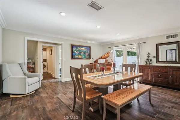a dining room with furniture a rug and a window